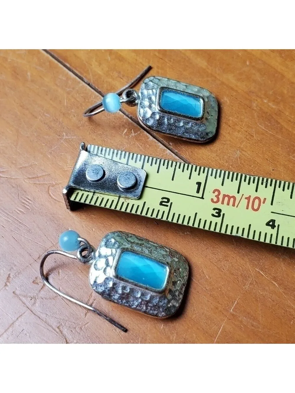 NWOT earrings, silver colored with light blue stone
